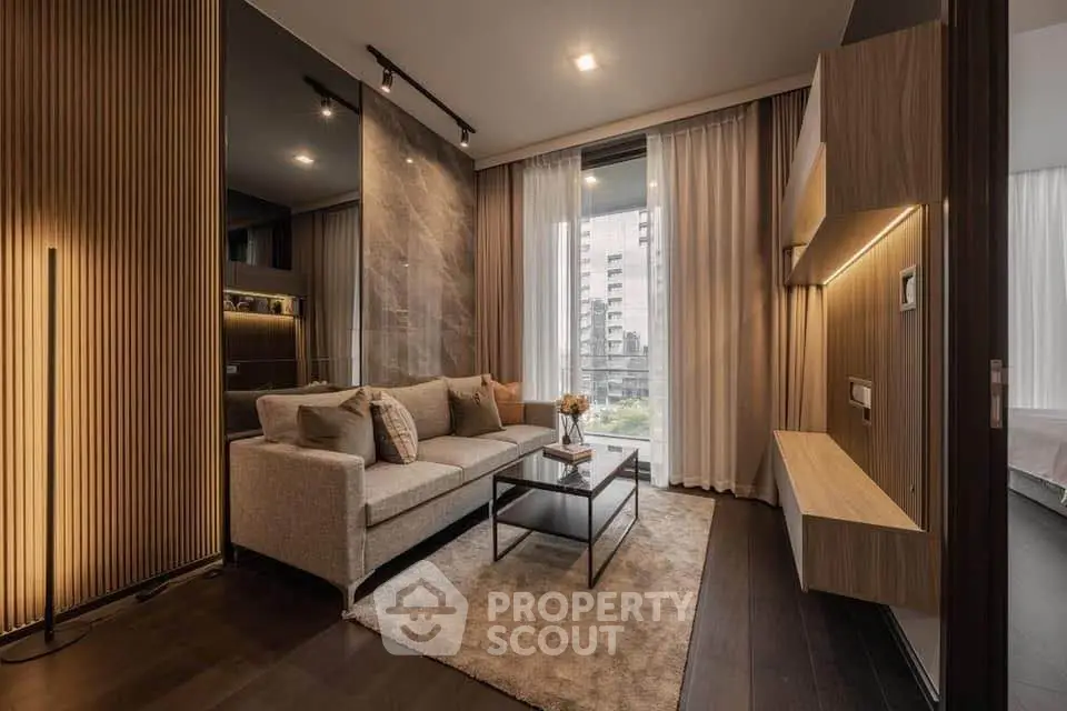 Modern living room with elegant decor and large window view in a stylish apartment.