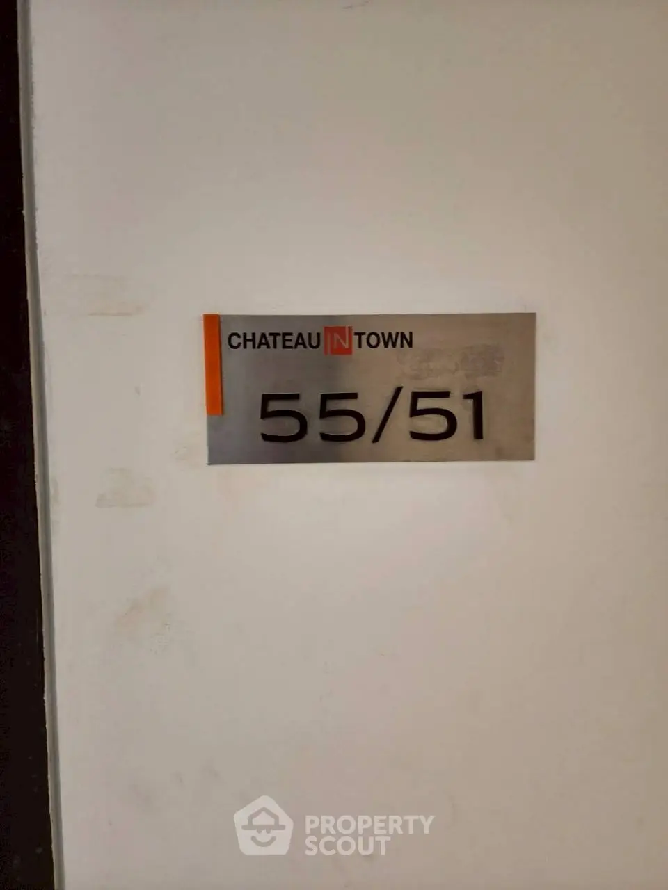 Chateau in Town building unit number 55/51 sign on wall