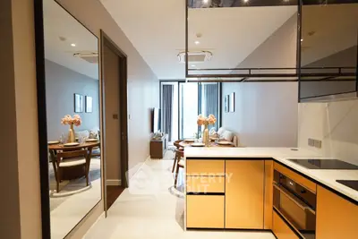 Modern open-plan kitchen and living area with stylish decor and natural light.