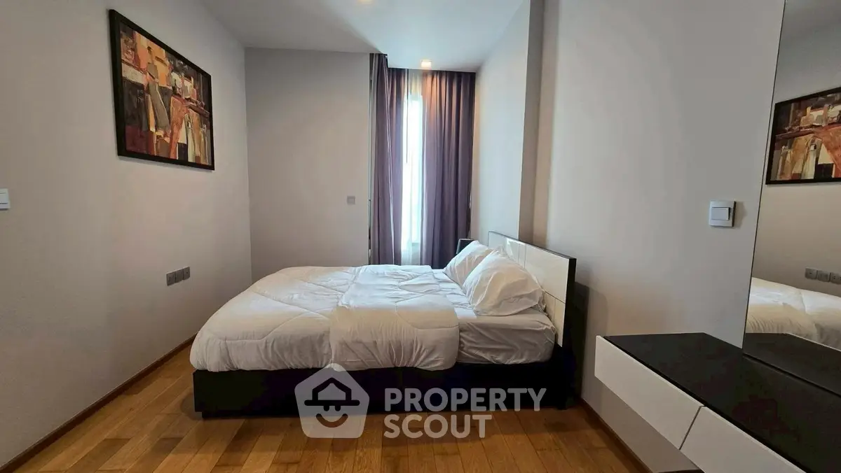 Modern bedroom with wooden flooring and elegant decor