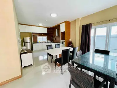 Spacious open-layout kitchen and dining area with modern furnishings and ample natural light.