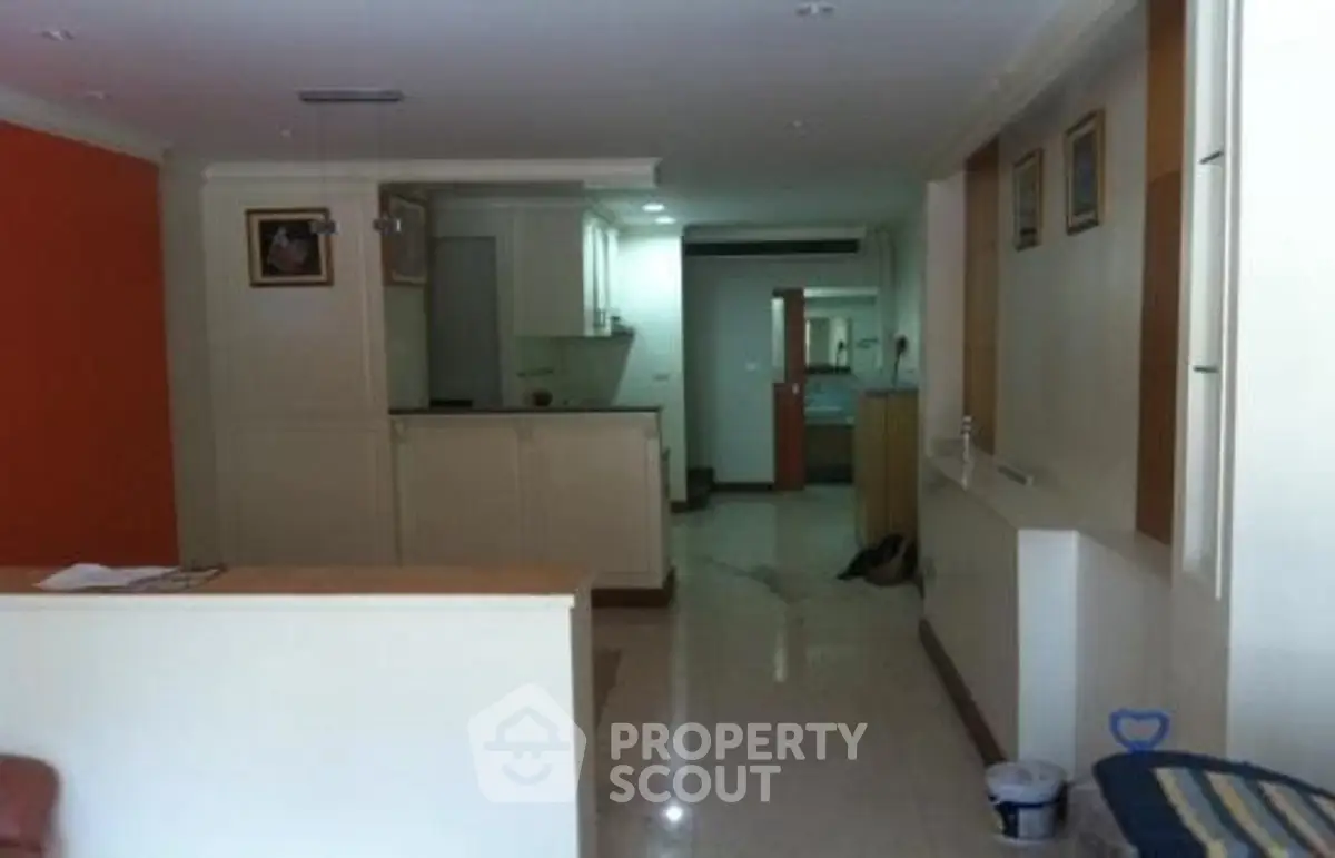 Spacious open-plan living area with modern kitchen and elegant decor.