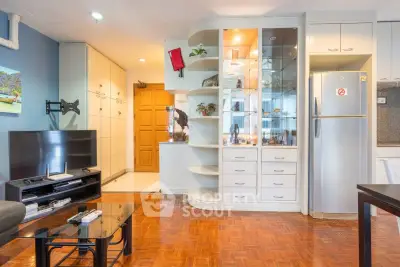 Spacious living room with modern decor and built-in storage in a stylish apartment.
