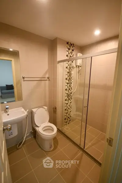 Modern bathroom with glass shower enclosure and stylish tile accents