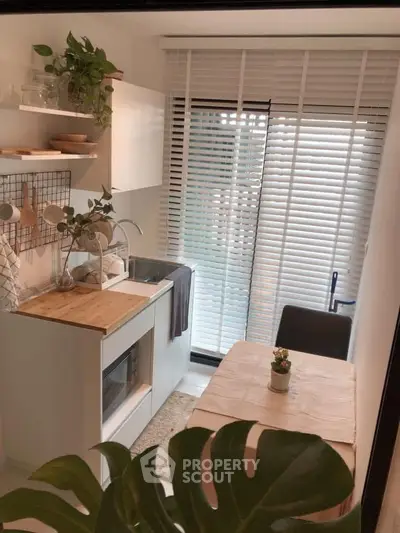 Charming kitchen with modern design, featuring open layout, sleek cabinetry, and natural light from large window.