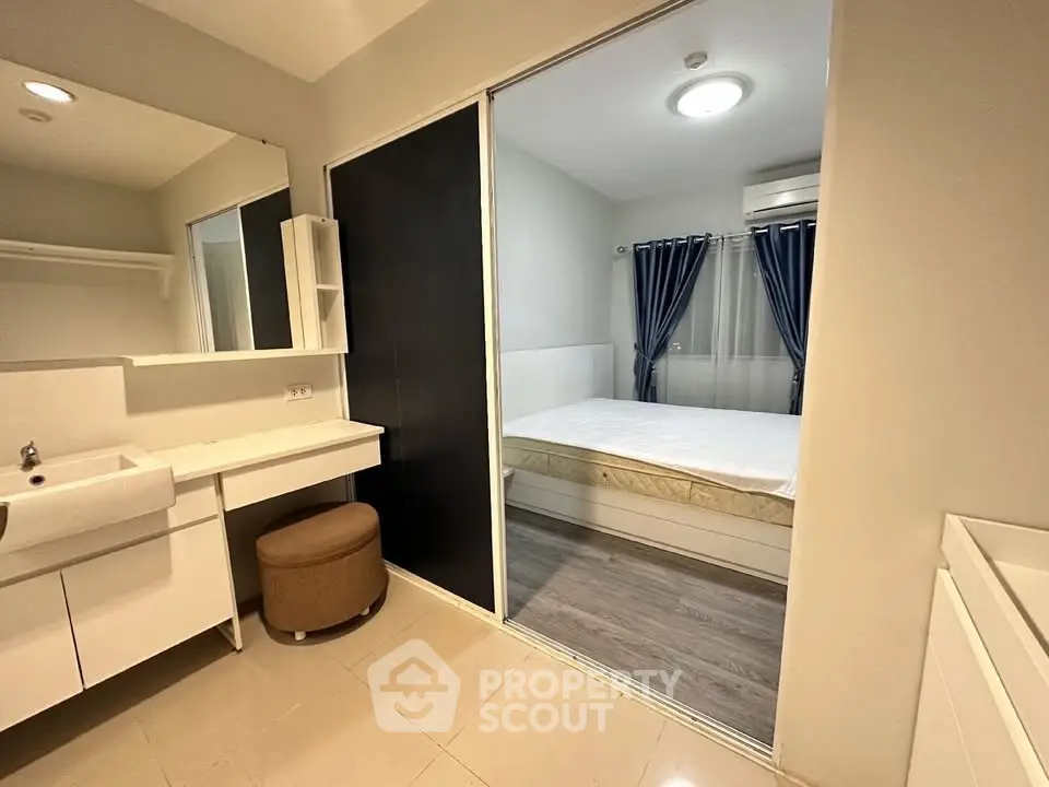 Modern bedroom with ensuite bathroom featuring sleek design and cozy ambiance.