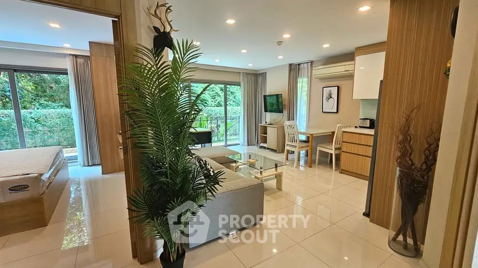 Modern open-plan living room with elegant decor and lush garden view.