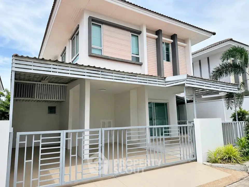 Modern two-story house with sleek design and spacious carport in a serene neighborhood.