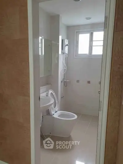 Modern bathroom with sleek fixtures and natural light, perfect for a contemporary home.