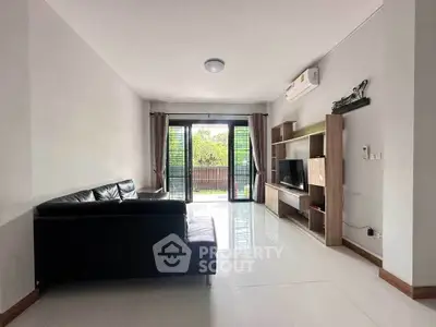 Spacious living room with modern furniture and large windows for natural light.