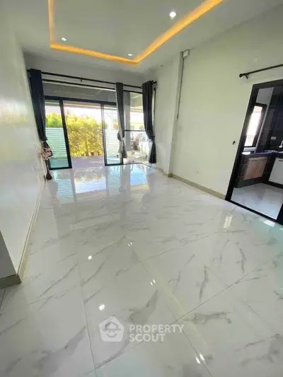 Spacious modern living room with marble flooring and large windows