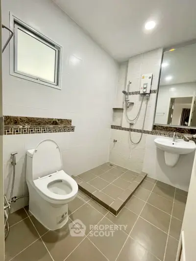 Modern bathroom with sleek fixtures and spacious shower area