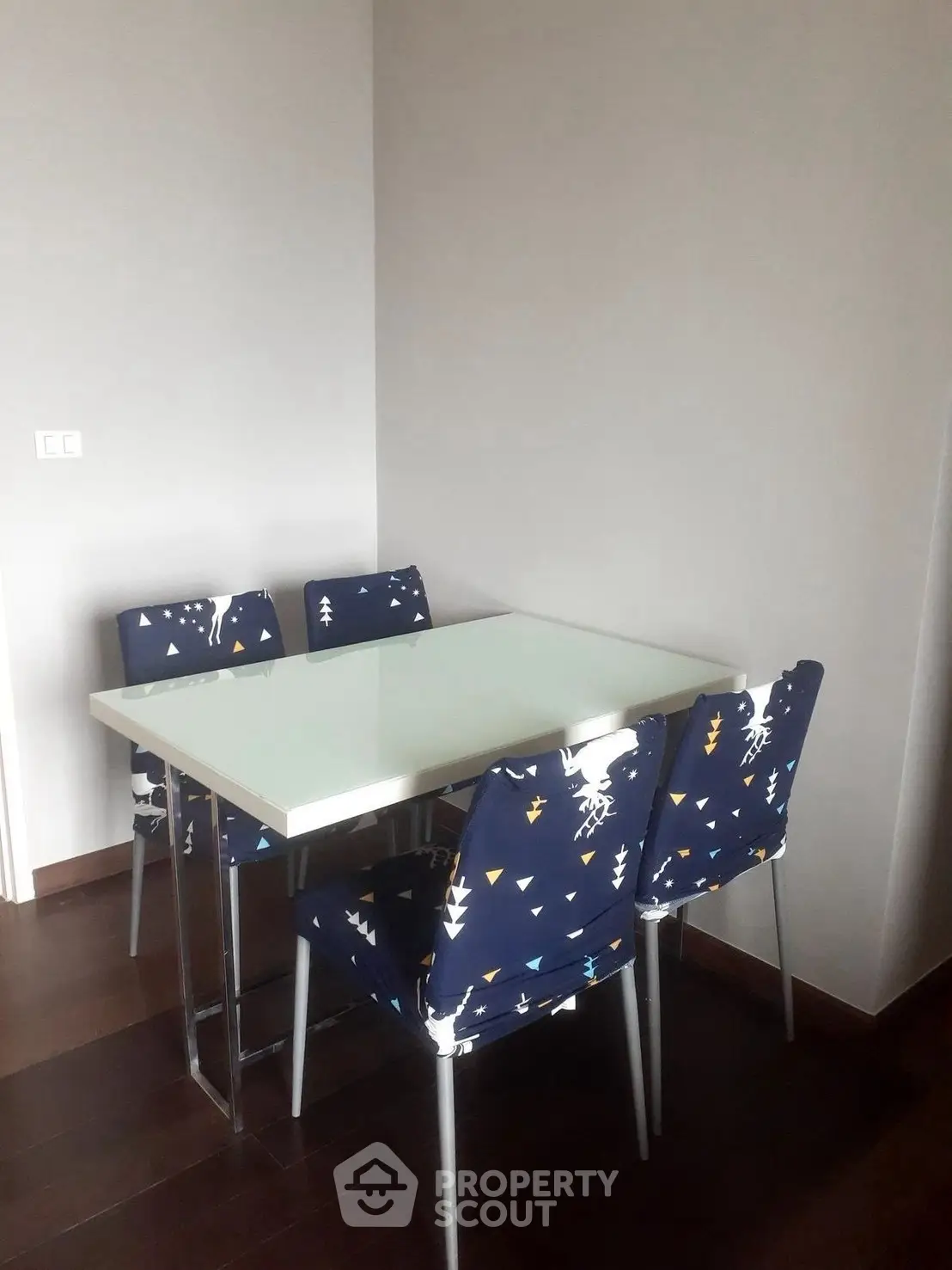 Modern dining area with stylish chairs and sleek table in a cozy setting.