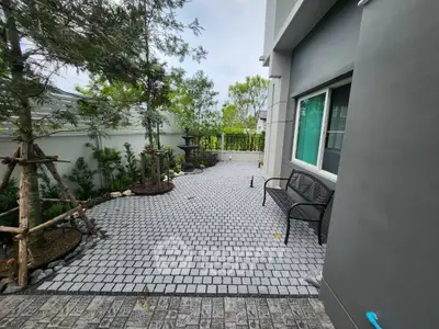 Charming garden patio with elegant paving and lush greenery