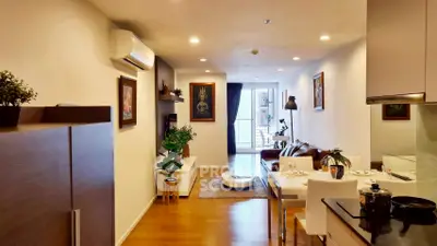 Modern living room with open layout and stylish decor, featuring a cozy seating area and dining space.