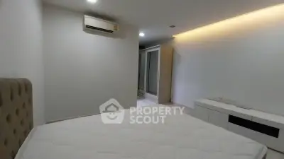 Modern minimalist bedroom with air conditioning and sleek storage solutions.