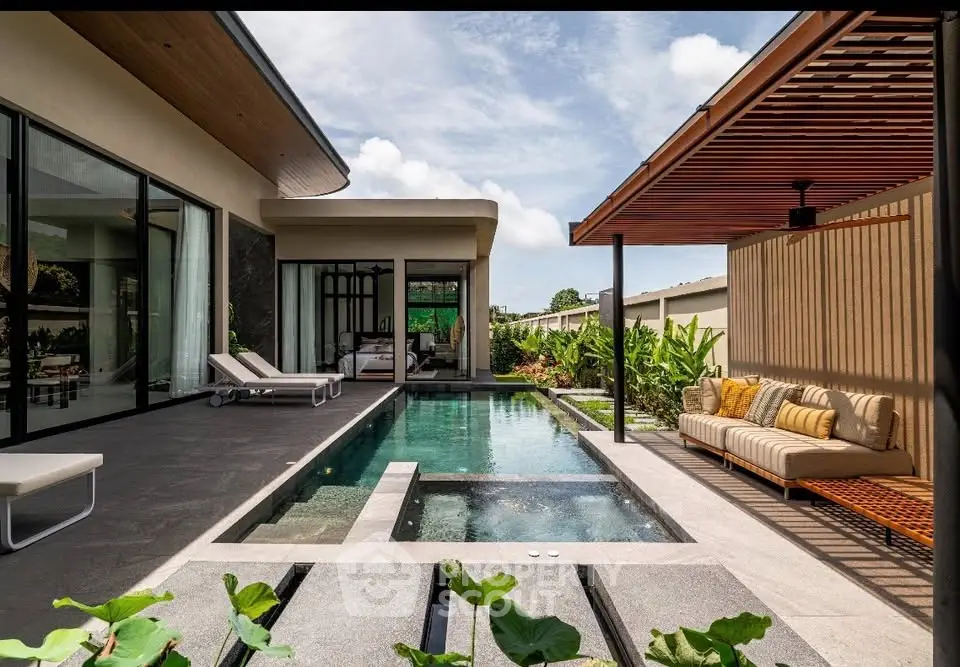 Luxurious modern villa with private pool and stylish outdoor seating area