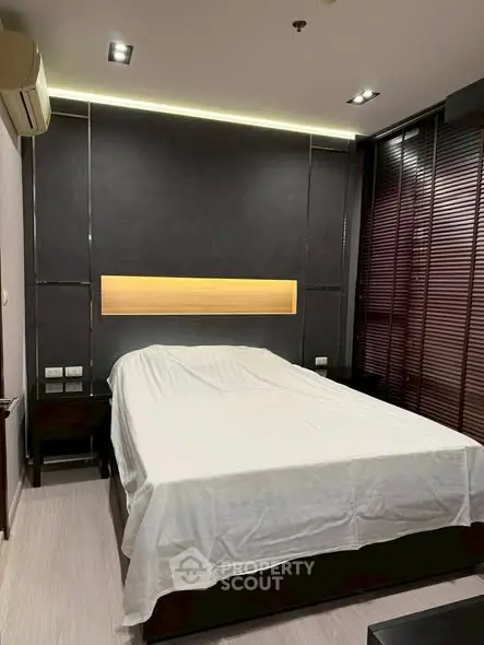 Modern bedroom with sleek design and ambient lighting, featuring a comfortable bed and stylish decor.