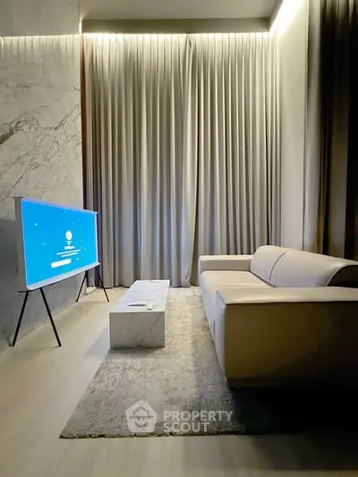 Luxurious modern living room with sleek sofa, marble coffee table, and large TV, perfect for relaxation.