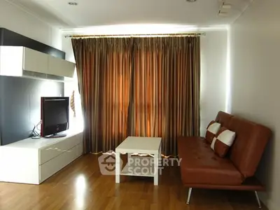 Modern living room with sleek furniture and elegant curtains