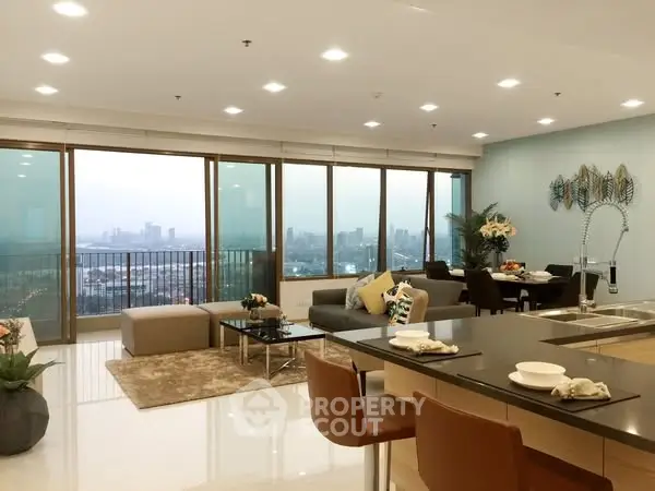 Luxurious open-plan living room with stunning city view and modern decor.