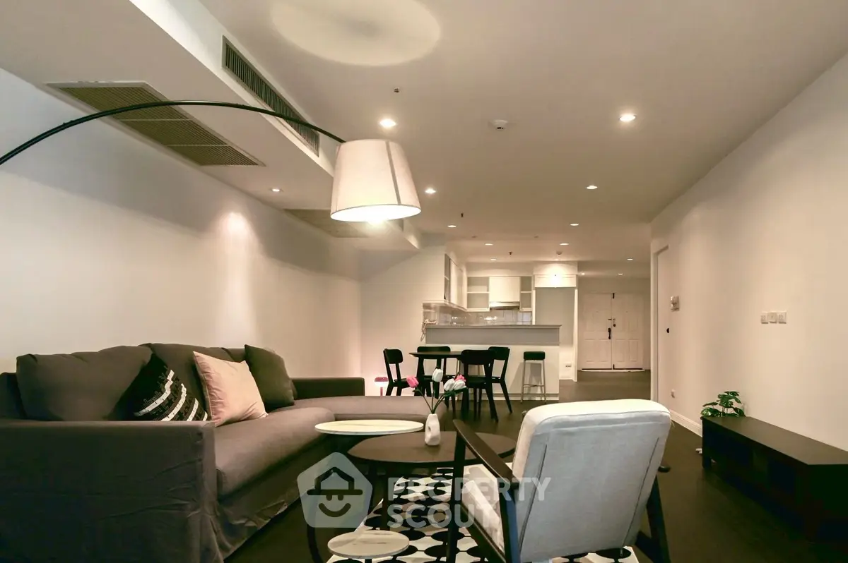 Modern living room with stylish furniture and open kitchen layout