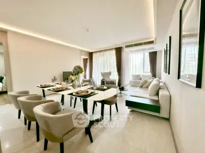 Elegant modern living room with dining area, featuring stylish furniture and natural light.