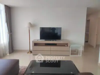 Spacious living room with modern TV setup and elegant decor