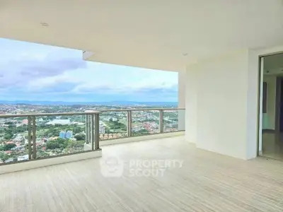 Spacious balcony with stunning panoramic city view in modern high-rise apartment.