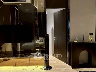 Modern living room with sleek black decor and stylish furnishings