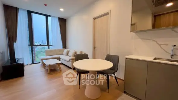 Modern living room with open kitchen and city view