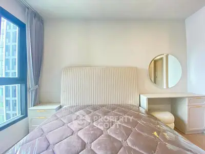 Modern bedroom with plush bed and elegant vanity set in bright apartment