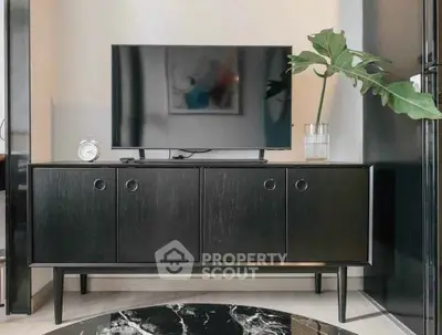 Modern living room with sleek black TV stand and stylish decor
