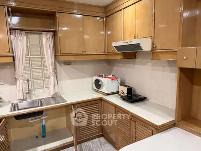 Charming kitchen with wooden cabinets and modern appliances