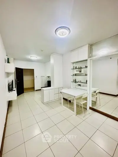 Modern minimalist living room with white furniture and tiled flooring