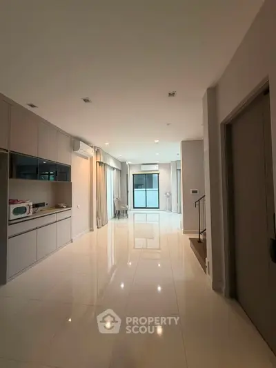 Spacious modern living area with sleek kitchen and large windows