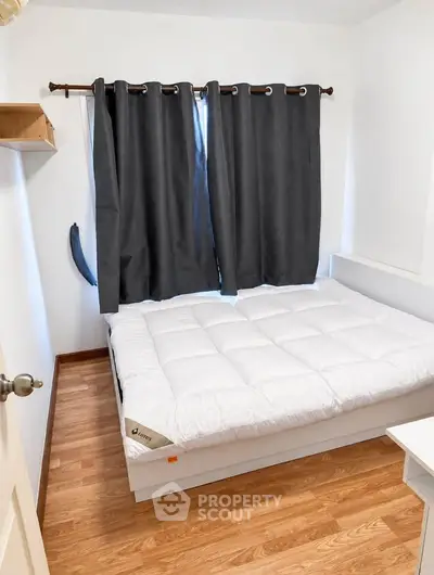Cozy bedroom with wooden flooring and modern decor