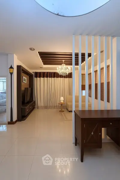 Elegant living room with modern decor and chandelier lighting