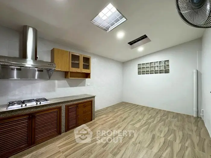 Spacious kitchen with modern gas stove and ample storage space