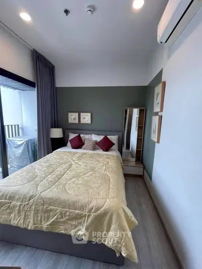 Cozy bedroom with modern decor and balcony access in stylish apartment