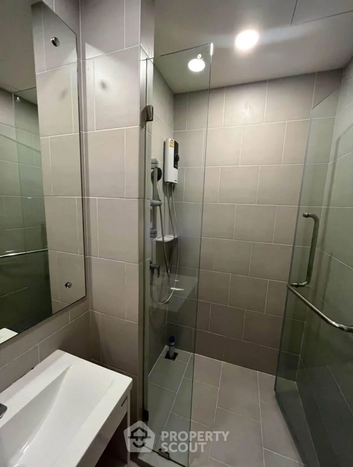 Modern bathroom with glass shower enclosure and sleek fixtures