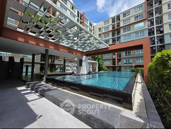Luxurious apartment complex with modern pool and stylish architecture, perfect for urban living.