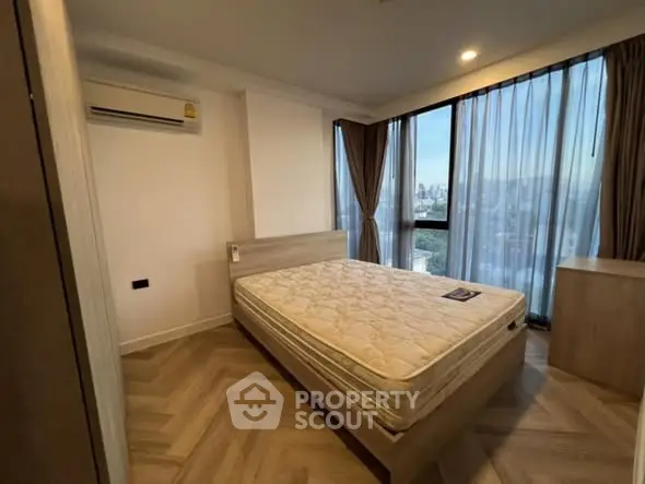 Spacious bedroom with city view and natural light