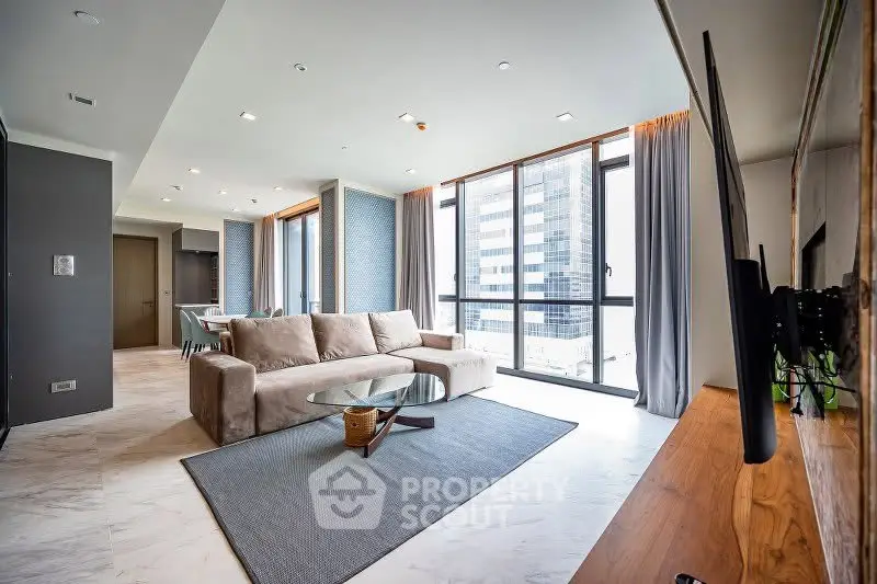 Spacious modern living room with large windows and city view in luxury apartment.
