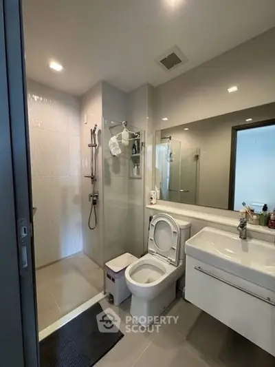 Modern bathroom with sleek fixtures and glass shower enclosure