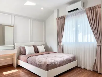 Elegant bedroom with natural light, modern decor, and air conditioning.