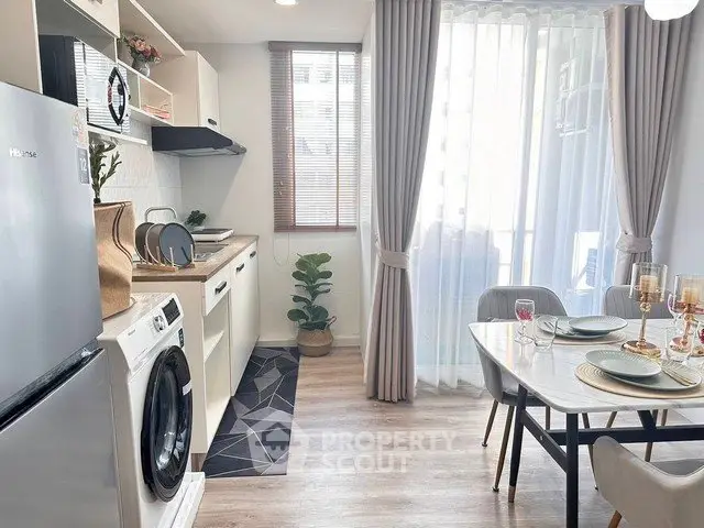 Modern kitchen with dining area, featuring sleek appliances and elegant decor, perfect for urban living.