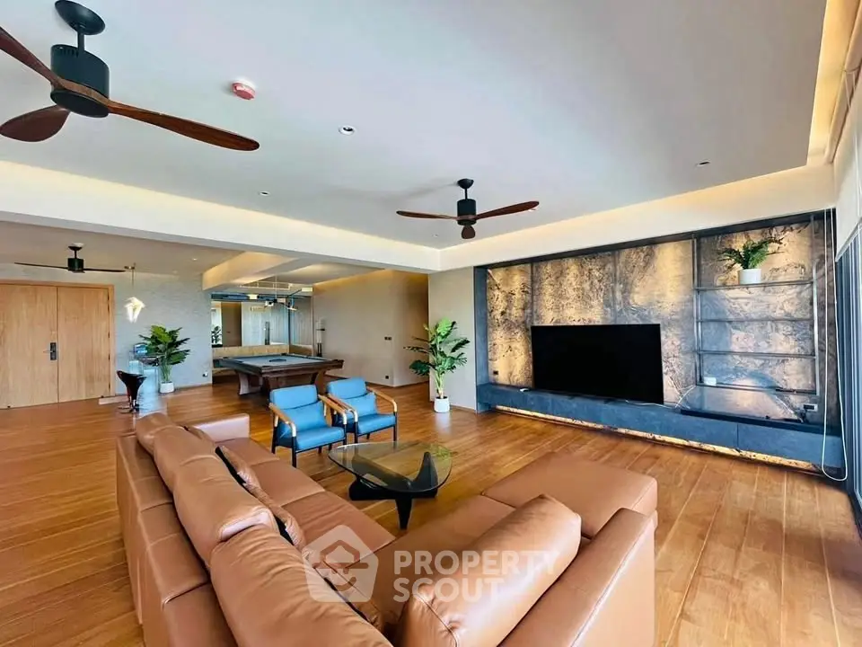 Luxurious living room with modern decor and spacious layout, featuring elegant furniture and stylish lighting.