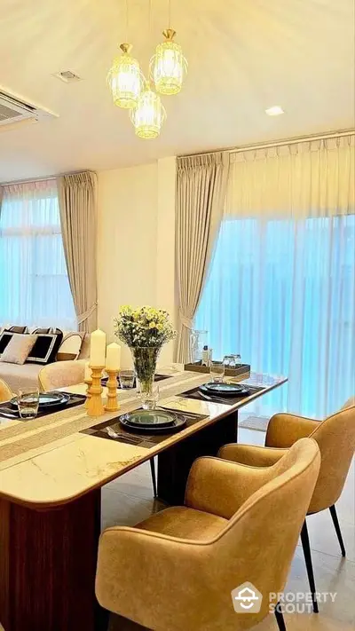 Elegant dining area with modern decor and natural lighting in a luxurious apartment.