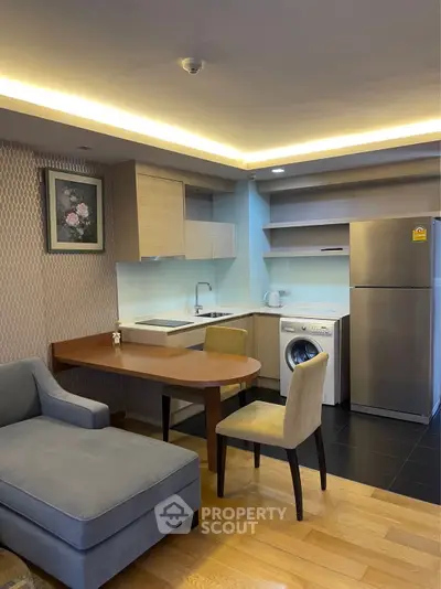 Modern open-layout kitchen with cozy living area and stylish furniture